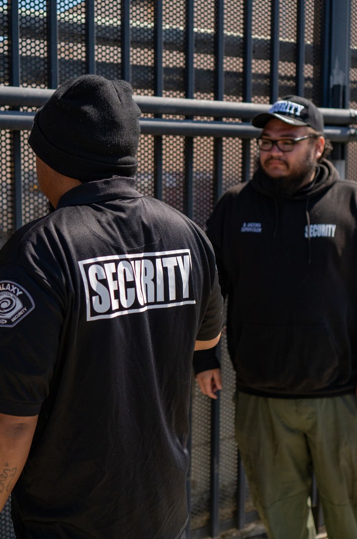 Two Galaxy officers at a steel gate