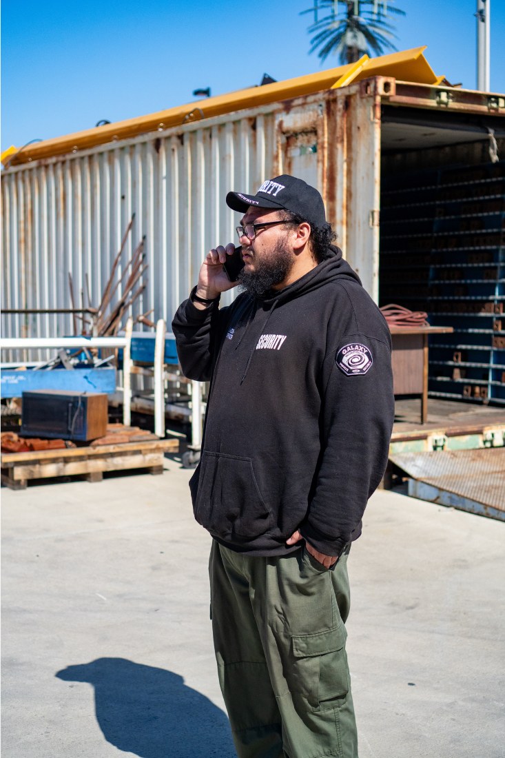 A Galaxy officer on the phone in a container yard